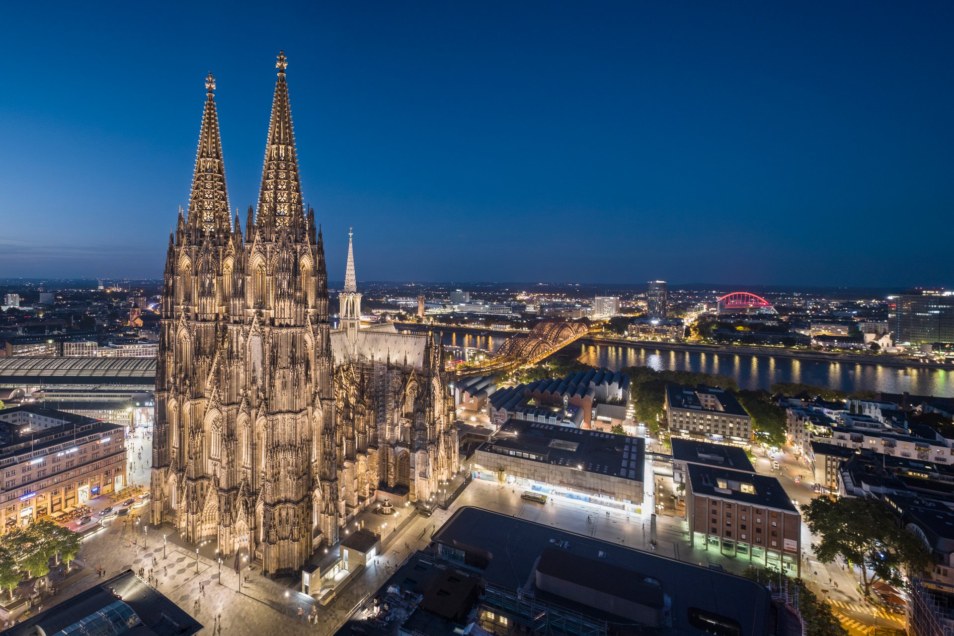 Cologne Cathedral illuminated at night showcasing Gothic architecture details with precision LED lighting on towers and buttresses